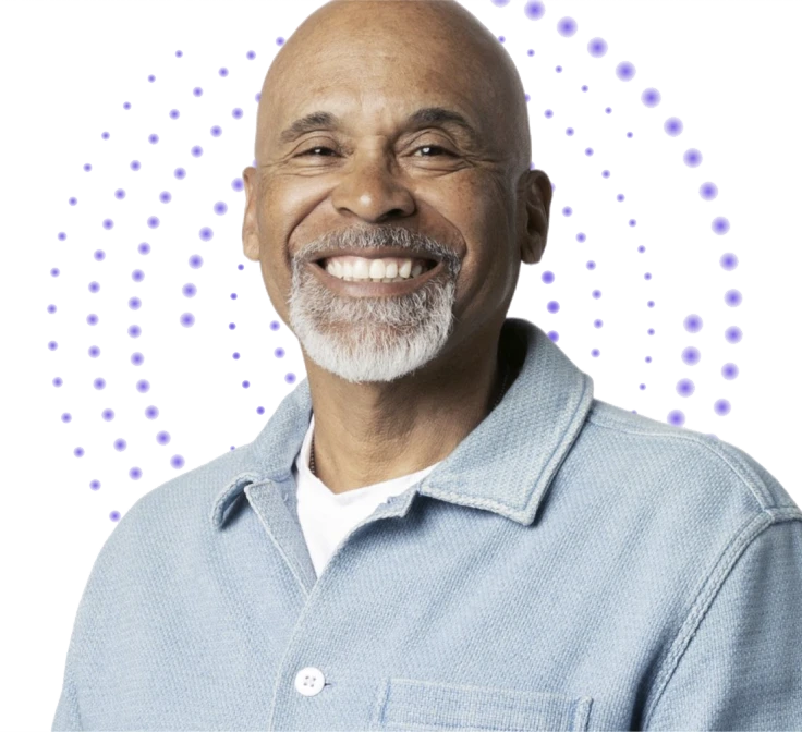 An older man looking straight ahead and smiling.
